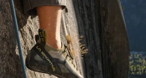 Why Stickier Climbing Shoe Rubber Isn’t Better Climber's foot in a La Sportiva TC Pro edging on a small granite crimp in low evening light
