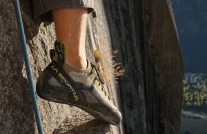 Why Stickier Climbing Shoe Rubber Isn’t Better Climber's foot in a La Sportiva TC Pro edging on a small granite crimp in low evening light