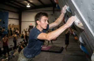 Bouldering Competition Training: 12-Week Peaking Plan A climber executing a high-intensity dynamic move during a training session.