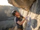 Mental Training for Climbing: A 4-Week Protocol A rock climber pausing on a steep route to mentally prepare for the next move, highlighting the psychological aspect of the sport.