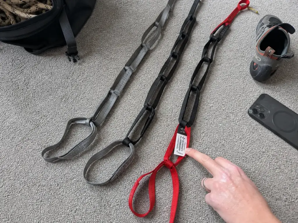 Two similar-looking tethers laid side by side to compare a fall-rated hybrid against a plain daisy chain