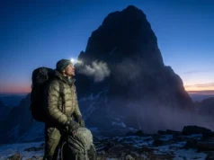 Grand Teton Owen Spalding Route: Complete Technical Guide A climber stands at the Lower Saddle looking up at the Grand Teton silhouette before dawn.