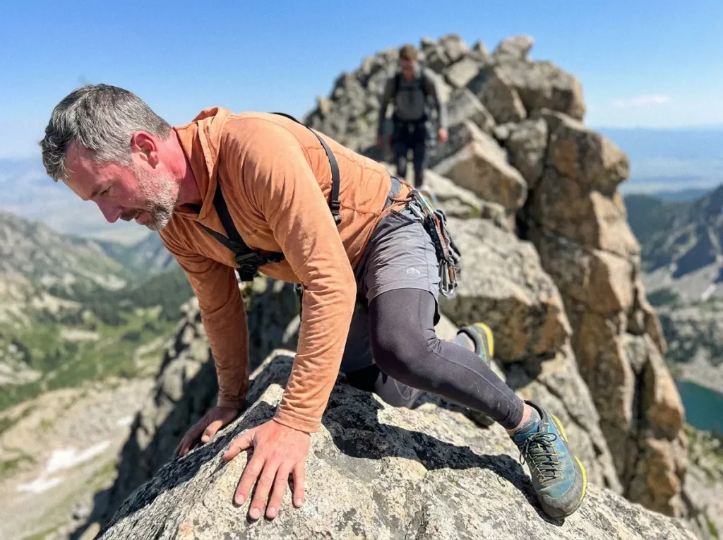 Climber scrambling class 3 Grand Teton granite in La Sportiva TX4 approach shoes