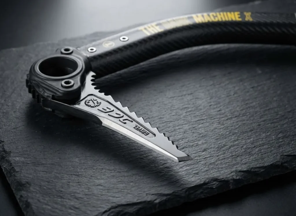 Studio macro shot of a Grivel Dark Machine ice tool, highlighting the carbon fiber weave texture and the ultra-thin geometry of the steel pick designed for brittle ice.