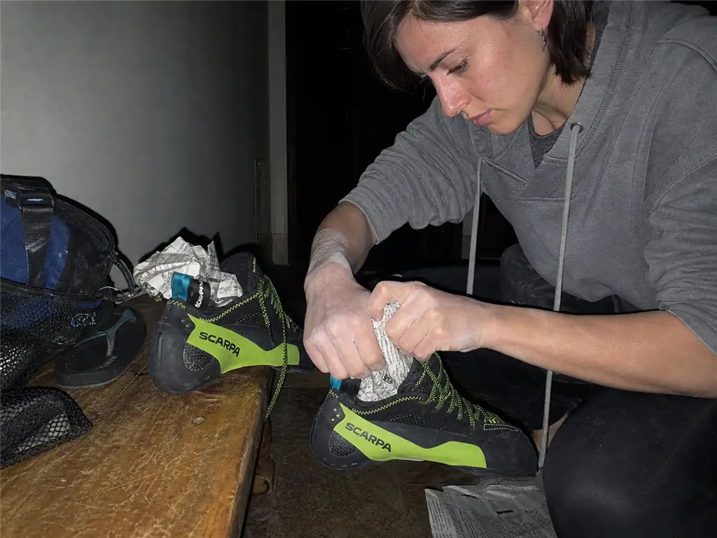 Climbing shoes drying with newspaper stuffed in the toe box to hold the downturn shape overnight