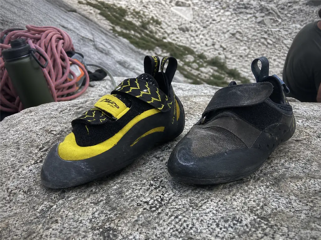 A well-used La Sportiva Miura VS still holding its downturn beside an older shoe that has gone flat