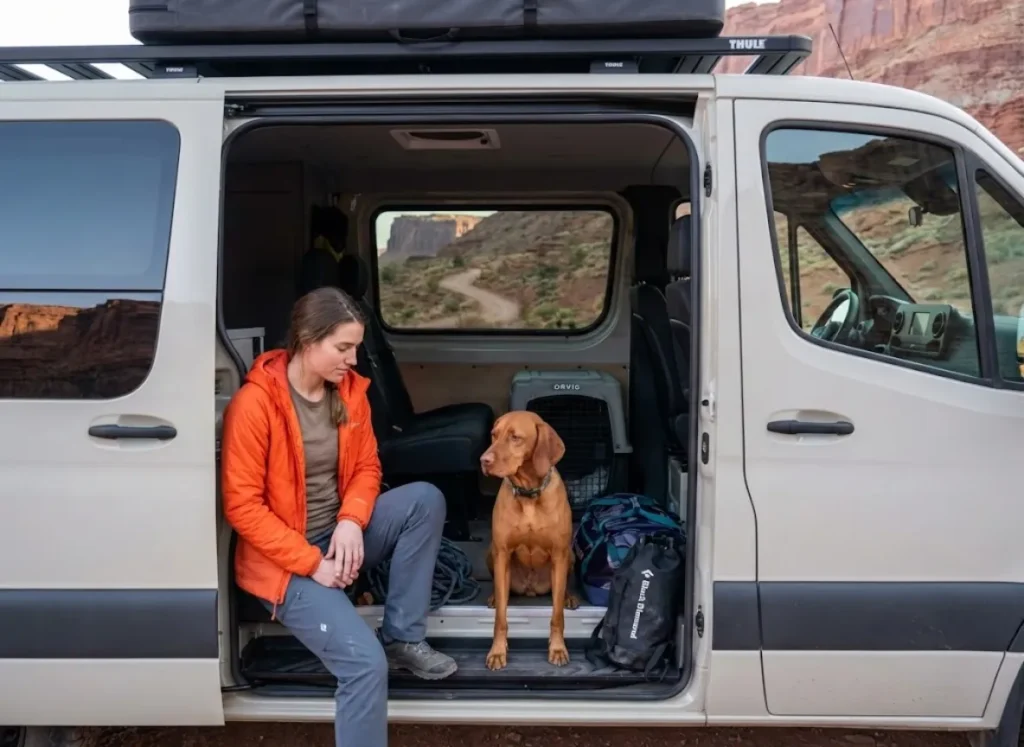 Climber making go or no-go decision about bringing dog to crag at trailhead