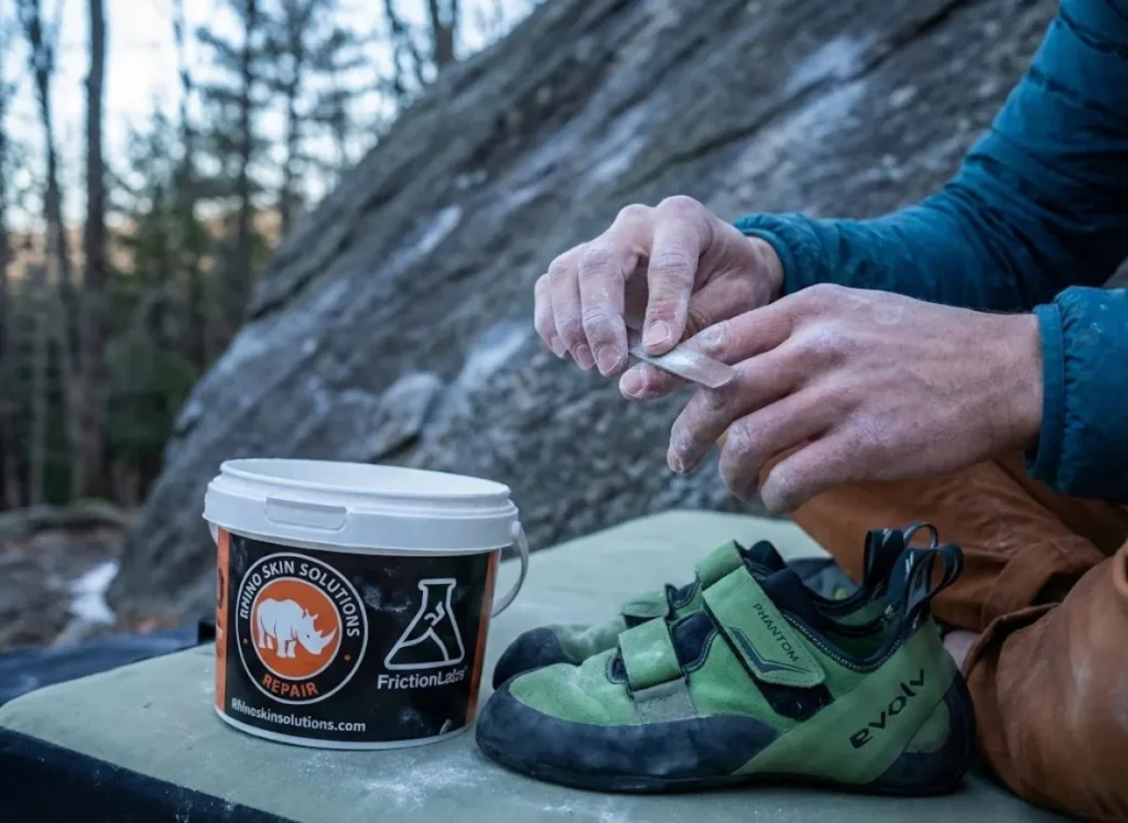 Climber sanding fingertips for skin care before Magic Wood bouldering session