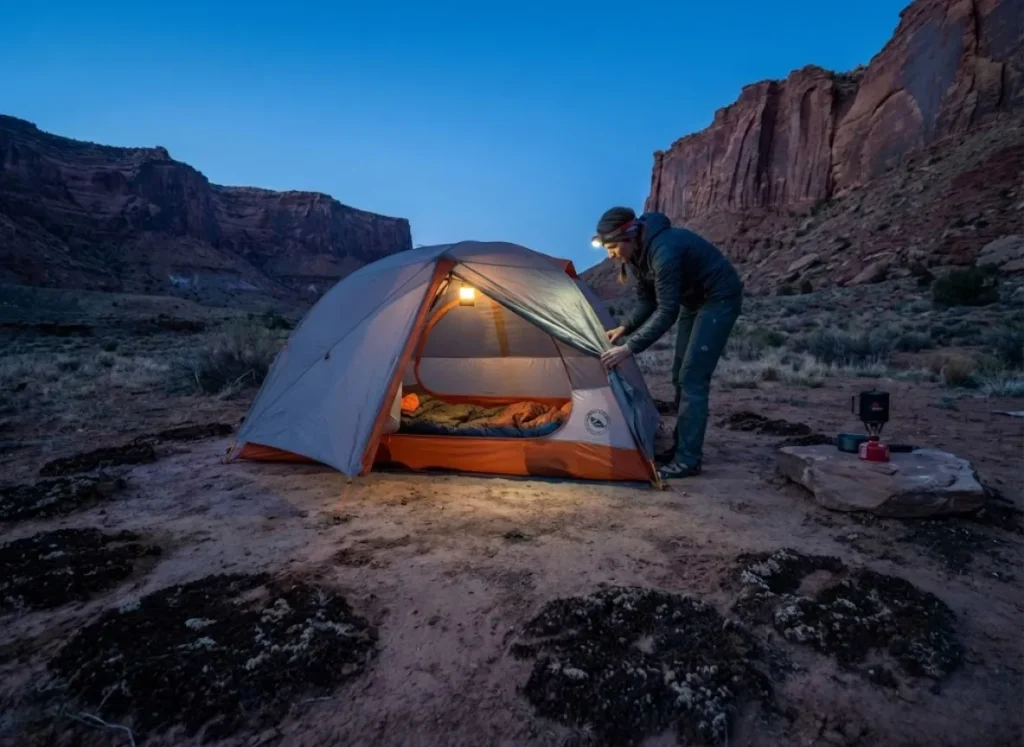Climber setting up camp on established bare ground at Indian Creek avoiding cryptobiotic soil