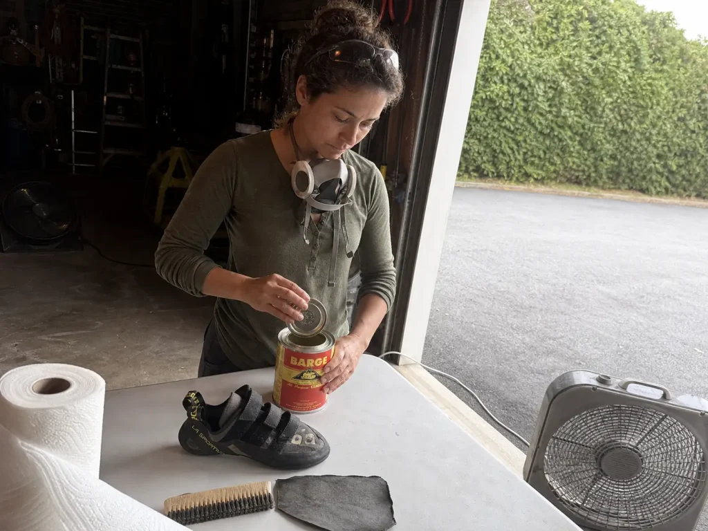 Working with contact cement at an open garage door with a respirator and a box fan for ventilation