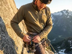 Best Alpine Climbing Harness? What 200 Pitches Taught Us Climber organizing gear on alpine harness at hanging belay on granite multi-pitch route