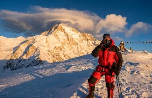 The Cho Oyu Expedition Mistakes Nobody Warns You About Mountaineer adjusting oxygen mask on snow ridge with Cho Oyu peak in background during expedition