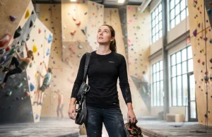 What Nobody Tells You Before Choosing a Climbing Gym Climber evaluating a modern climbing gym interior before choosing a membership