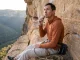 When You Eat Matters More Than What for Climbing Climber eating on a belay ledge mid-route during a multi-pitch climbing day for performance nutrition