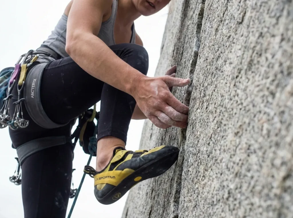 Close-up of finger jam technique in thin granite crack showing proper rotation and knuckle depth