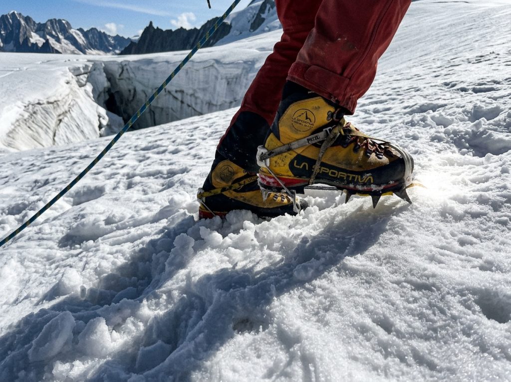 Beginner mountaineer roped up on Mount Baker's Easton Glacier in midday sun