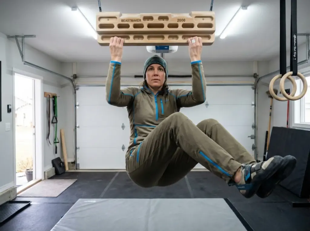 Climber performing progressive hangboard rehab exercise during finger pulley recovery