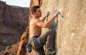 The Lock Off Strength Fix Most Climbers Never Try Climber executing a lock-off strength technique on a steep limestone sport route at golden hour