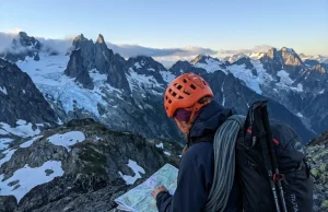 What Guides Won’t Tell You About North Cascades Climbs Solo climber studying route on North Cascades ridgeline with glaciated peaks in background