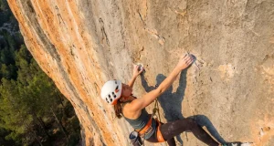 How to Project a Sport Route Without Wasting Burns Climber projecting a sport route reaches for a crimp on steep limestone