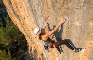 How to Project a Sport Route Without Wasting Burns Climber projecting a sport route reaches for a crimp on steep limestone