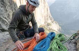 Rope Diameter Selection Guide (From a Gear-Obsessed Climber) Climber comparing three climbing ropes of different diameters on a granite ledge