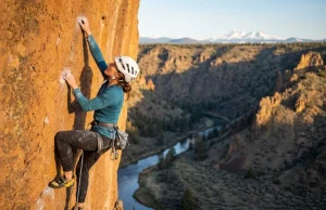 What Nobody Tells You About Climbing Smith Rock Climber leading a sport route on volcanic tuff at Smith Rock Oregon with Cascade mountains in background