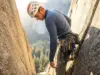 I Tested 3 Rack Systems for 6 Months on Real Routes Climber reaching for cam on organized harness rack during multi-pitch crack climb