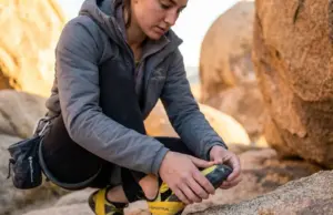 Sole Worn Through? Here’s the Exact Moment to Resole Climber examining worn climbing shoe rubber to determine if resole is needed