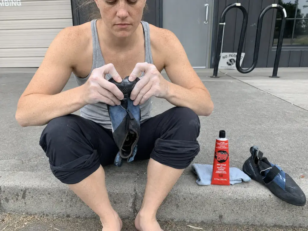 Flexing a climbing shoe to check whether the delaminated gap closes, the weight test before gluing