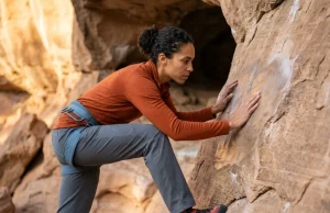 Does Climbing Damage Rock? What the Science Actually Shows Climber examining polished sandstone surface showing wear from repeated ascents at a busy crag