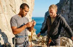 How to Vet a Stranger Before You Rope Up Traveling Two climbers performing a partner check at a limestone crag before roping up while traveling