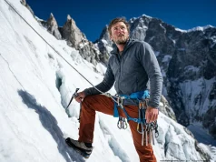 Island Peak Expedition Guide For Beginners (Field-Tested) Mountaineer in Mountain Hardwear parka climbing a steep icy headwall on an Island Peak expedition