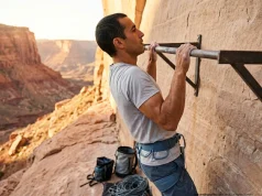 How to Bulletproof Your Climbing Shoulders for Good Climber performing scapular pull-up on outdoor training wall for shoulder injury prevention