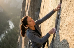 What Climbing History Gets Wrong About Women Female climber leading a granite crack route in Yosemite with Patagonia and Black Diamond gear during golden hour