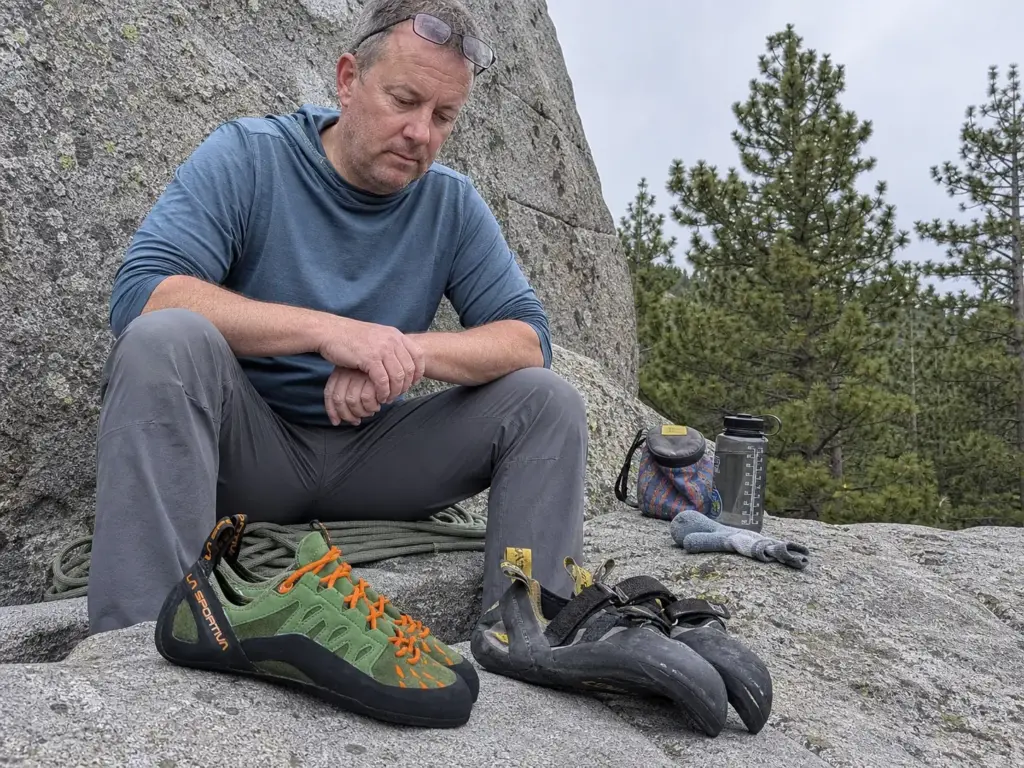 Beginner and aggressive climbing shoes side by side showing different downturn and break in timelines