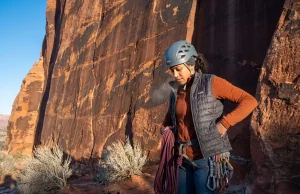 I’ve Climbed These Destinations in Winter — Honest Ranking Climber layering up at base of warm desert sandstone wall in winter morning light