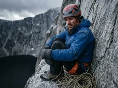 4 Bivouac Survival Mistakes That Get Climbers Killed Climber in harness huddled on narrow alpine granite ledge during unplanned bivouac, bivouac survival