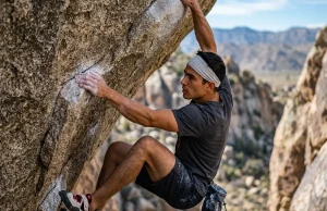How to Break a Bouldering Plateau That Won’t Budge Boulderer executing dynamic reach on steep granite overhang — bouldering plateau training