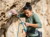 Bouldering vs Sport Climbing the Physics Behind Each Climber clipping a quickdraw on a limestone sport route illustrating bouldering vs sport climbing differences