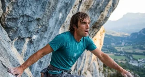 5 Chris Sharma Sends That Rewrote Climbing History Sport climber in a dynamic lunge on steep limestone, evoking Chris Sharma's powerful style
