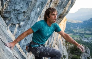 5 Chris Sharma Sends That Rewrote Climbing History Sport climber in a dynamic lunge on steep limestone, evoking Chris Sharma's powerful style