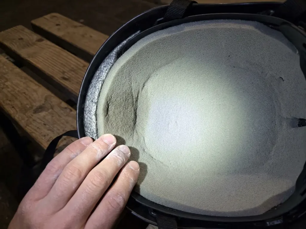 Cross-section diagram of EPS foam interior of a climbing helmet showing compression zone after impact