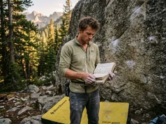 Climbing Performance Plateau? The Physics Fix Climber reviewing his climbing performance plateau diagnosis guide logbook at the boulders