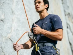 7 Common Belay Mistakes That Cause Accidents Outdoors Climber belaying with a Petzl GriGri, brake hand locked below the device on a granite sport crag