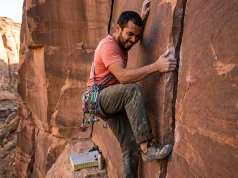 How to Crack Climb for Beginners the Right Way Beginner climber on splitter hand crack in red sandstone canyon, learning crack climbing basics