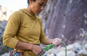 The Devils Lake Climbing Guide Wisconsin Locals Trust Female climber preparing gear at base of Devils Lake cliff