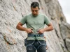 Do You Need a Full Body Harness Climbing? Climber checking full body harness fit at iliac crest before lead climbing on granite