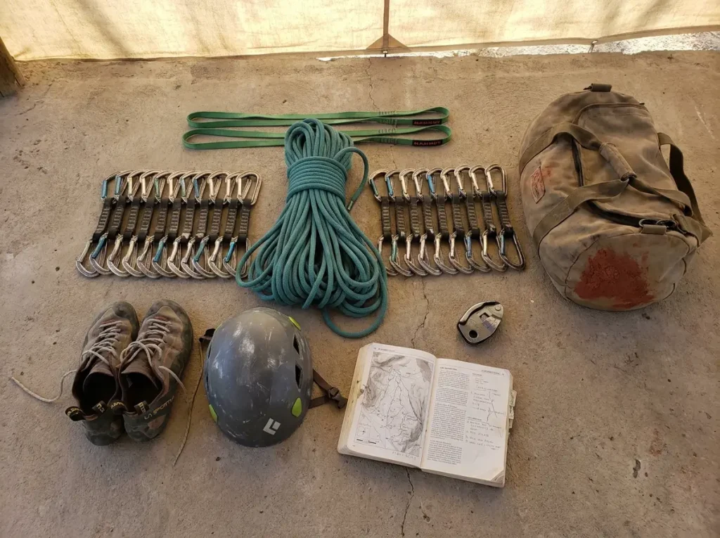 Climbing gear laid out for El Potrero Chico trip including 60m rope quickdraws and helmet
