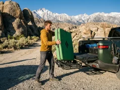 EV Charging at Remote Crags What Most Guides Miss Climber packing gear into a Rivian electric vehicle charging for climbing road trips.
